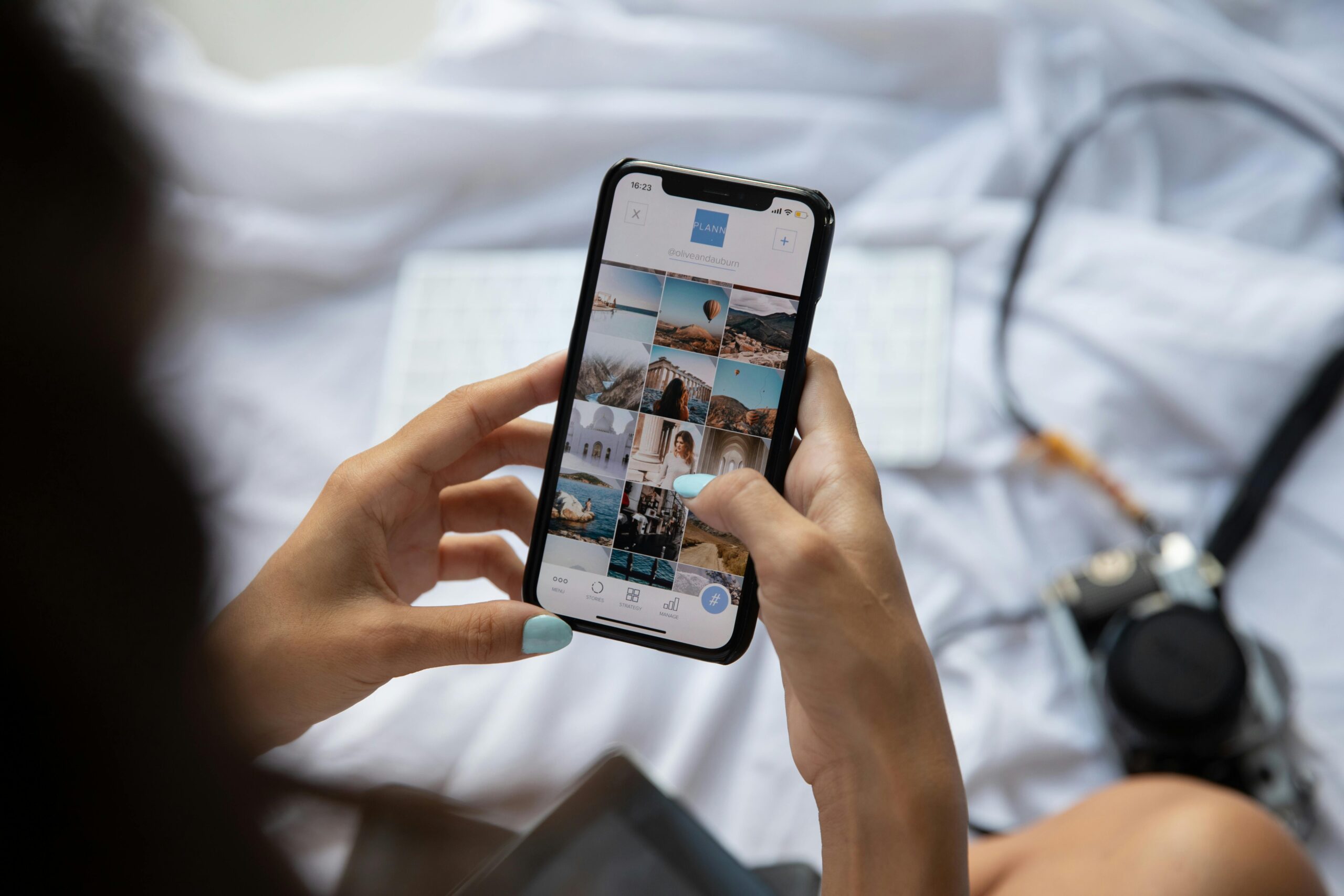 A person interacts with a smartphone displaying social media content in Bali, Indonesia.